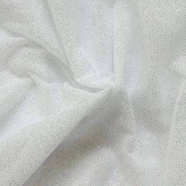 White Glitter Mesh fabric features all over silver glitter on 2-way stretch white polyester mesh making it ideal for both semi-fitted and draped garments.