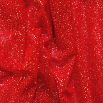 Red Silver Glitter Mesh fabric features all over silver glitter on 2-way stretch red polyester mesh making it ideal for both semi-fitted and draped garments.