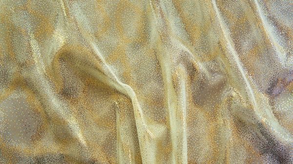 Fairydust Nude Foil Mesh Fabric features an enchanting gold foil pattern on sheer, nude non-stretch mesh base fabric for a soft, dreamy glow.