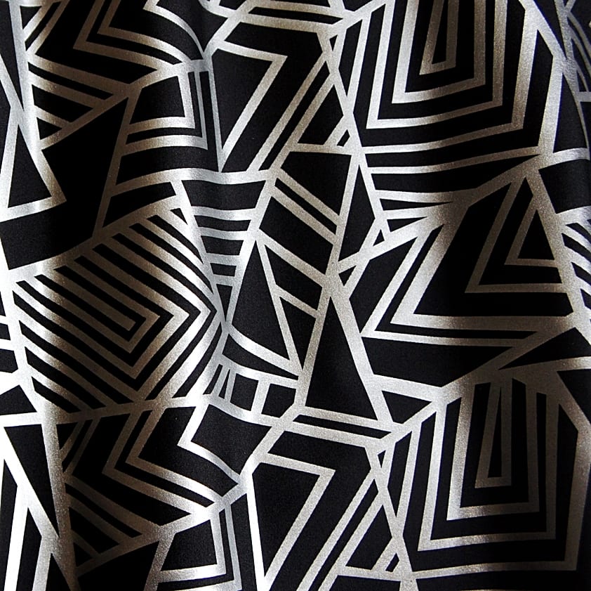 Geometry Matte Silver Geometric fabric features bold geometric designs in a sleek matte silver foil on black stretch base fabric for a stunning contrast effect.  - SOLID STONE FABRICS, INC.