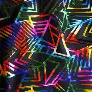 Multi Colored Geometric fabric features bold rainbow geometric foil designs on black stretch base fabric for a stunning contrast effect.