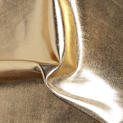Liquid Foil - Gold Stretch Lame fabric features full coverage metallic foil on 4 way stretch base fabric for an intense liquid shine effect.