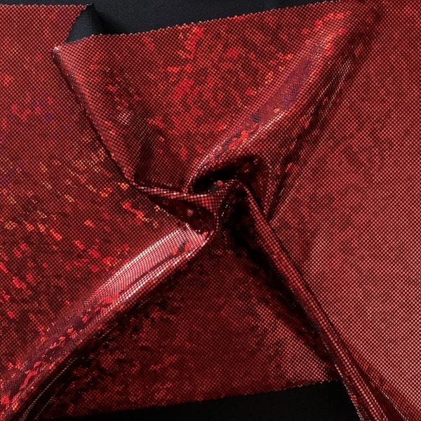 Red broken glass fabric featuring black stretch base fabric topped with red shattered glass holographic foil, for brilliant shine and sparkle.