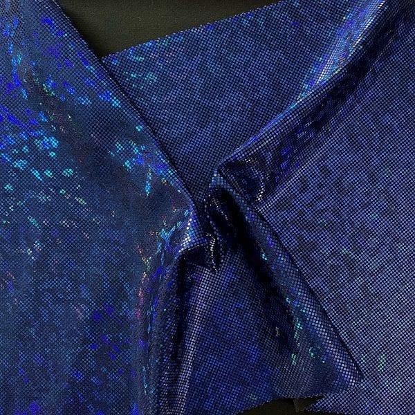 SOLID STONE FABRICS, INC. - Royal blue broken glass fabric featuring black stretch base fabric topped with royal blue shattered glass holographic foil, for brilliant shine and sparkle.