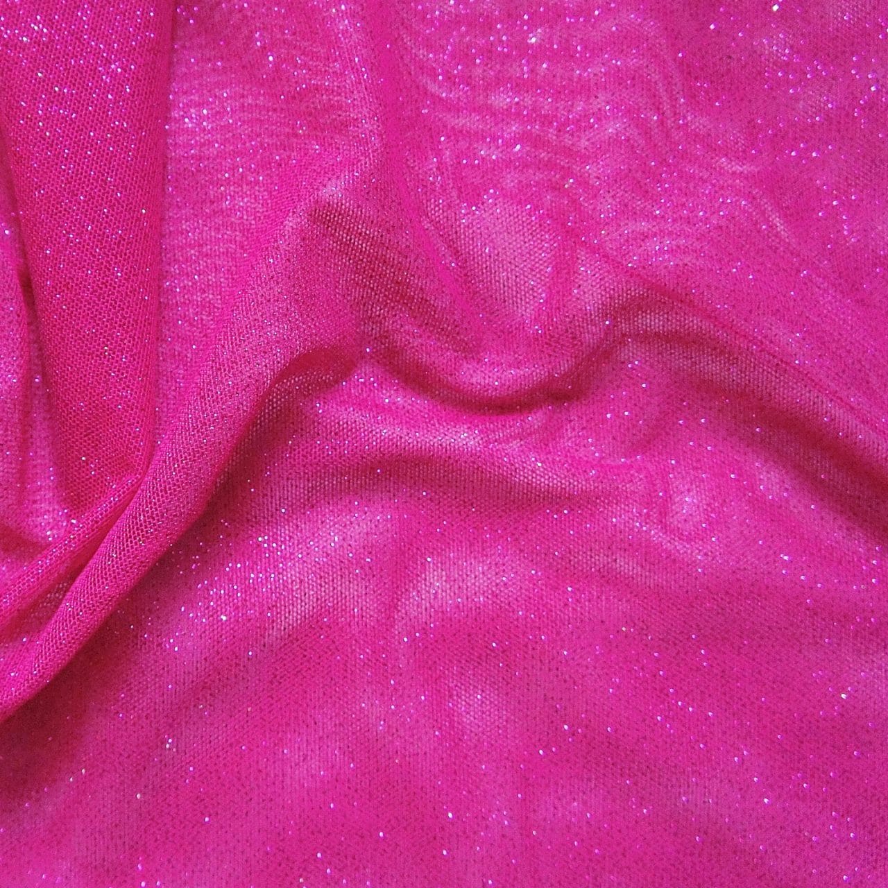Pink Glitter Mesh fabric features all over glitter on 2-way stretch polyester mesh making it ideal for both tight fitting and draped garments.